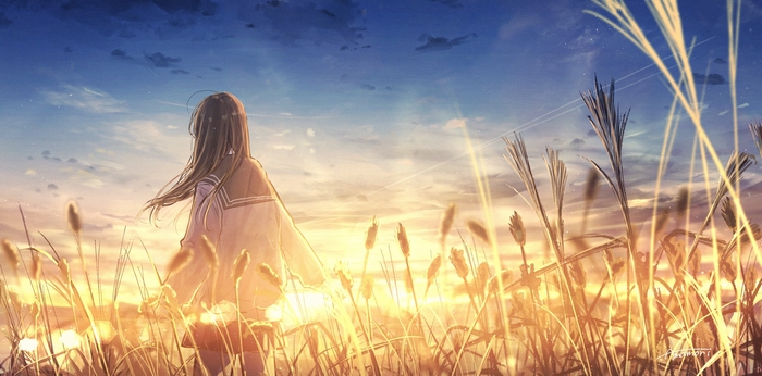 Girl in a field at sunset
