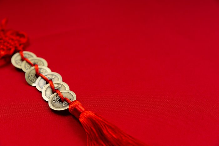 Chinese Coins and Red Tassel on Red Background