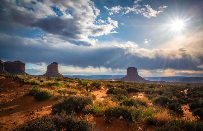 Monument Valley Desert Landscape with Sun and Clouds 4K