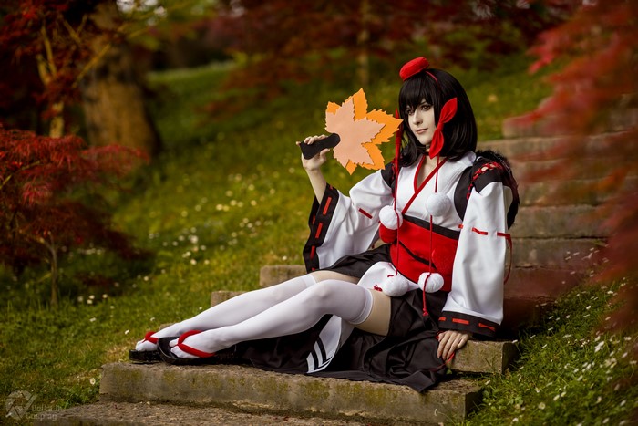 Woman in Kimono Cosplay holding a maple leaf