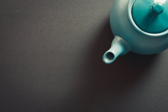 Teapot on a dark grey surface