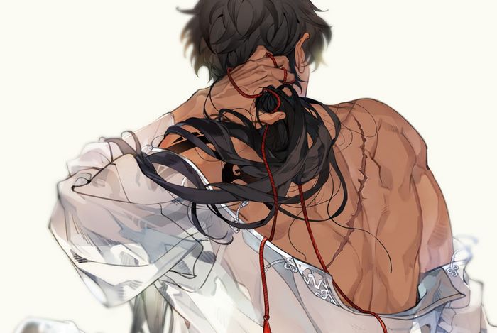 Man with scars and black hair tied with red string