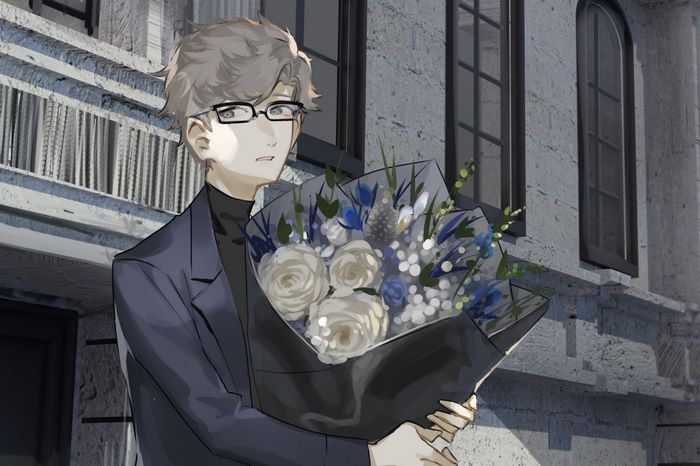 Man in suit holding a bouquet of flowers
