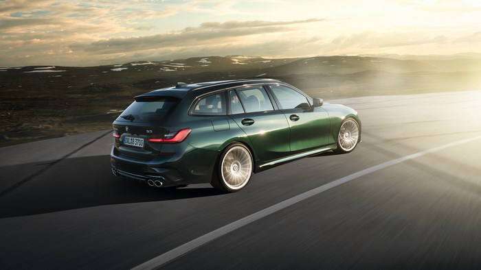 Green BMW Alpina B3 Touring driving on a road