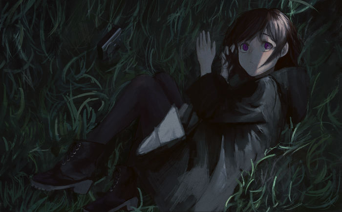 Girl with black hair lying in grass