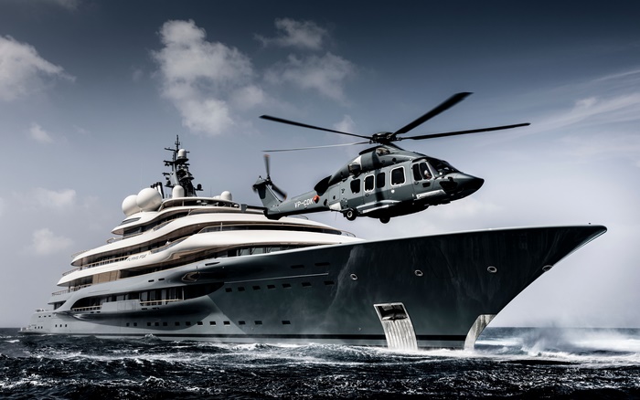 Helicopter flying over a luxury yacht