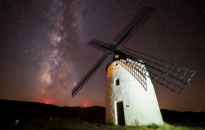 White windmill under a starry night sky