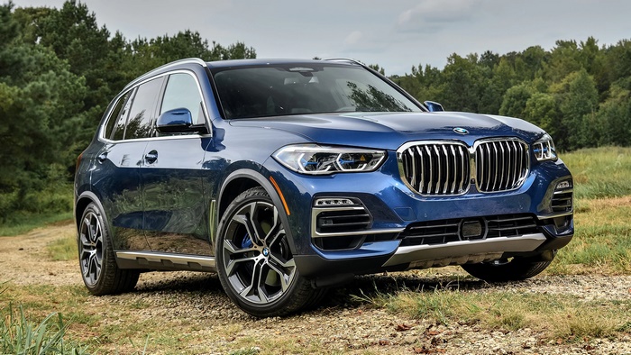 Blue BMW X5 SUV parked on a dirt road
