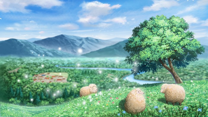 Sheep grazing in a green valley with mountains