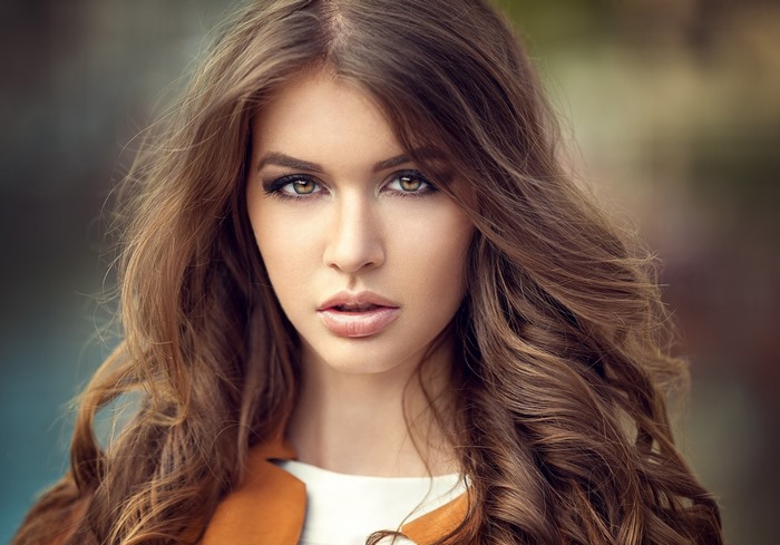 Close-Up Portrait of a Woman with Loose Curls