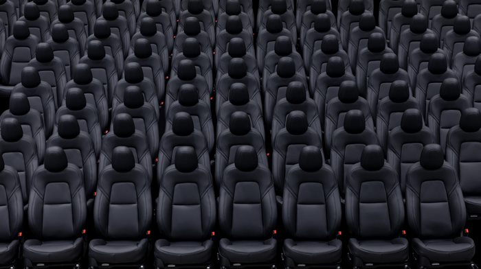 Rows of black Tesla car seats in a factory