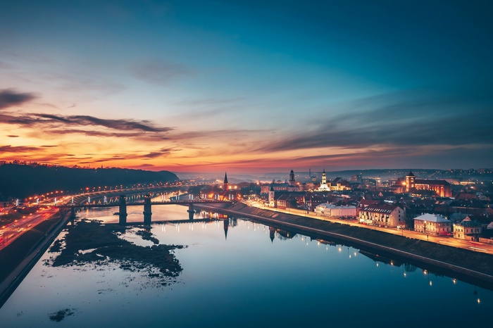 Kaunas cityscape at sunset with river reflection