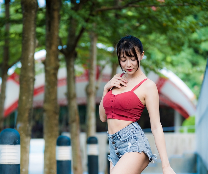 Asian woman with black hair wearing shorts
