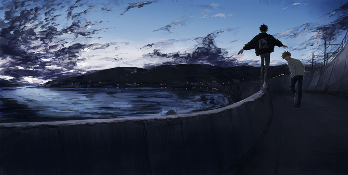 Two boys walking on a wall by the sea at dusk