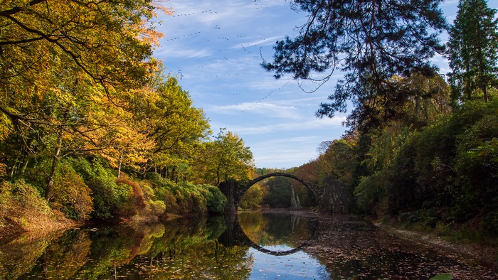 Rakotzbrücke bridge in autumn with reflection
