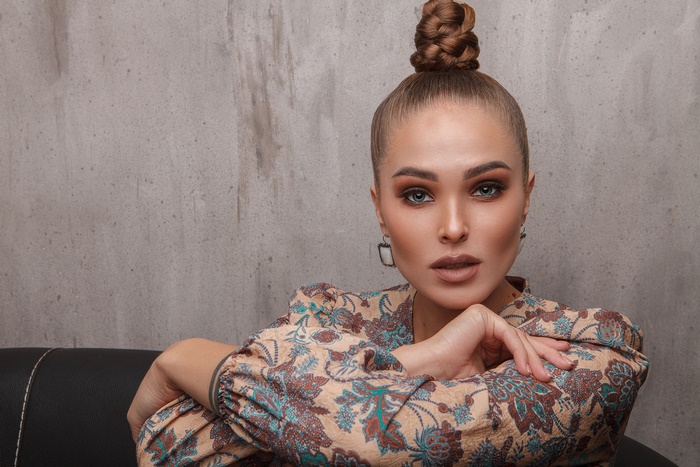 Woman with blue eyes and braided bun