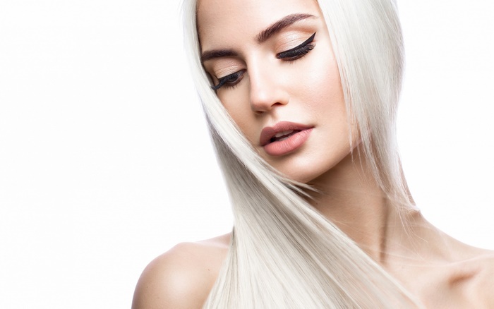 Woman with white hair and dramatic makeup