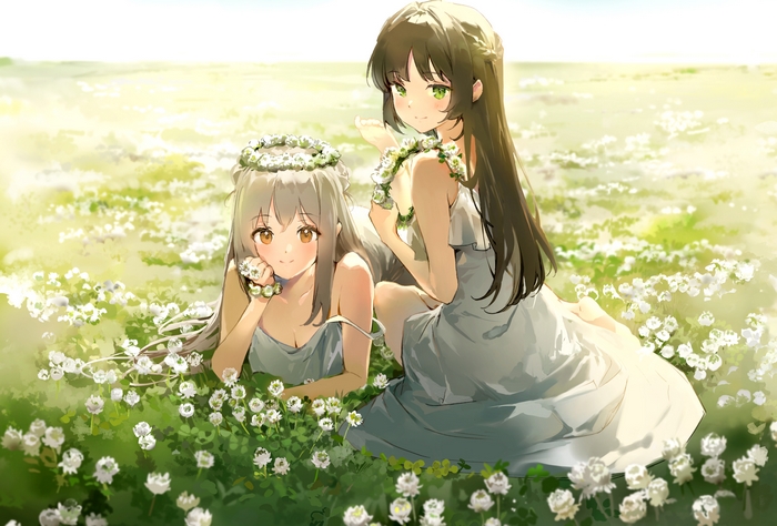 Two girls with flower crowns in a field of flowers