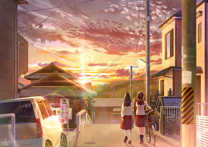 Two schoolgirls walk home at sunset with a bicycle