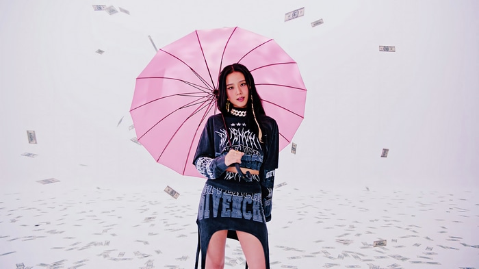 Jisoo from BLACKPINK with a pink umbrella and falling money