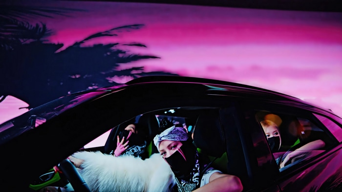 BLACKPINK members in a car with pink sky