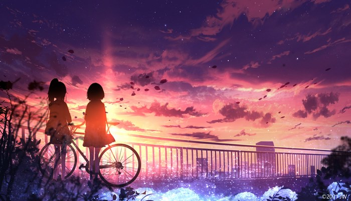 Two girls with a bicycle watching the sunset