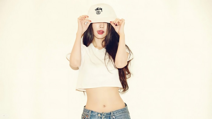 IU wearing a bucket hat and crop top
