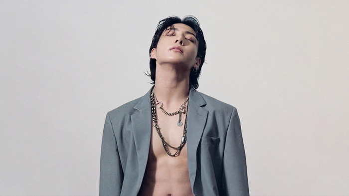 Jungkook in a grey suit with necklaces