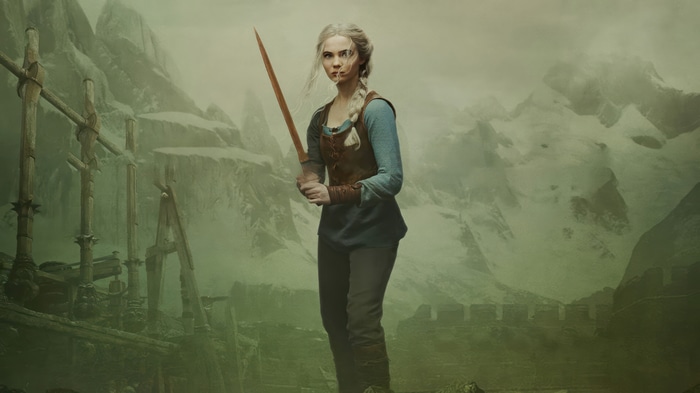 Ciri from The Witcher holding a sword in mountains