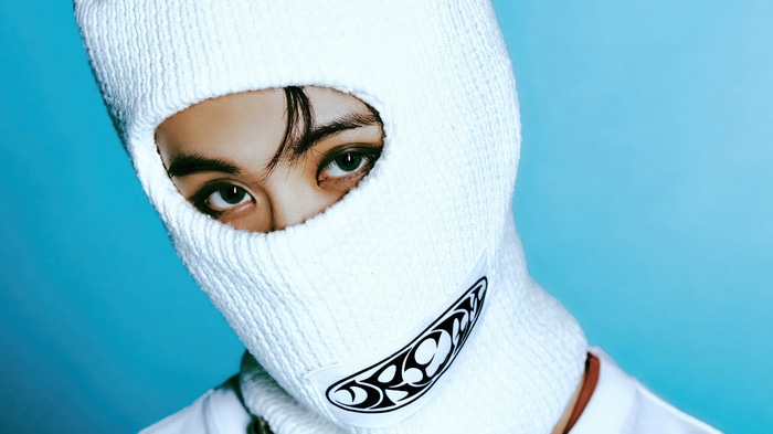 Mark from NCT DREAM wearing a white balaclava