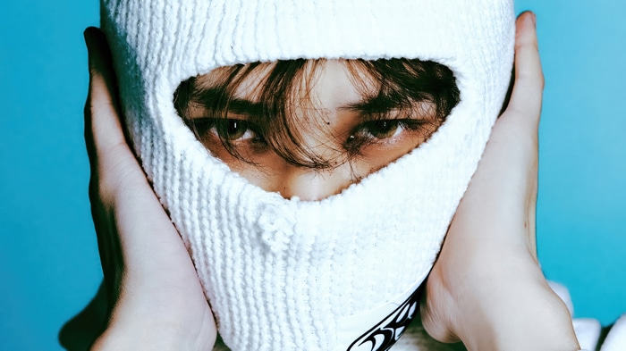 Chenle from NCT DREAM wearing a white balaclava