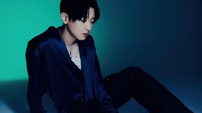 Chanyeol in a blue satin shirt and black pants
