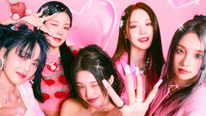 GIDLE members posing in pink outfits
