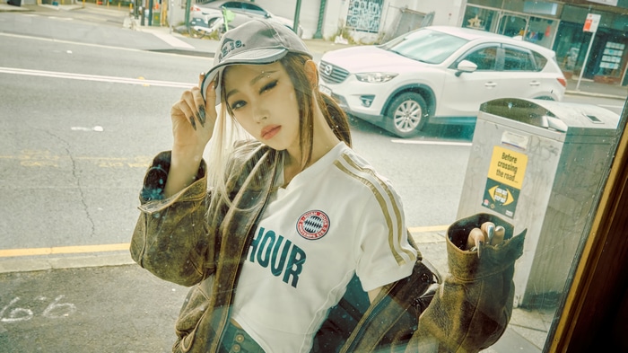 Giselle from Aespa wearing a cap and jacket