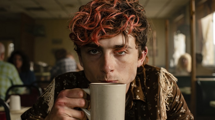 Timothee Chalamet drinks from a mug