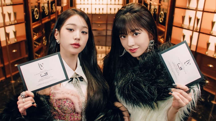 IVE's Wonyoung and Yujin holding IVE cards