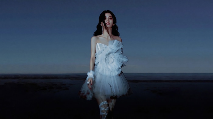 Jisoo in a white dress by the water