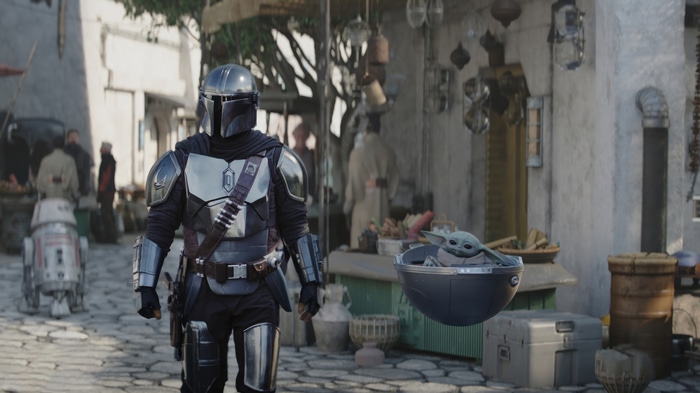 The Mandalorian and Grogu in a marketplace
