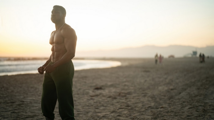Jonathan Majors on the beach at sunset 4K