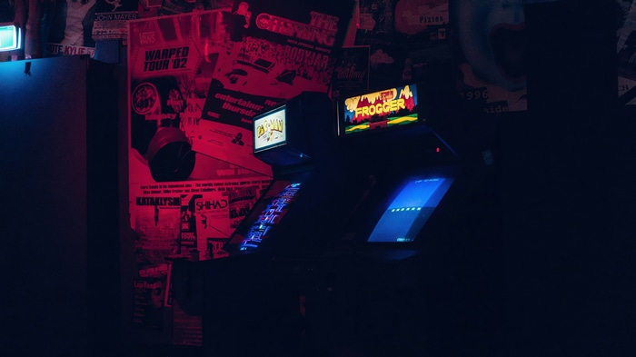 Frogger and other arcade games in a dark room