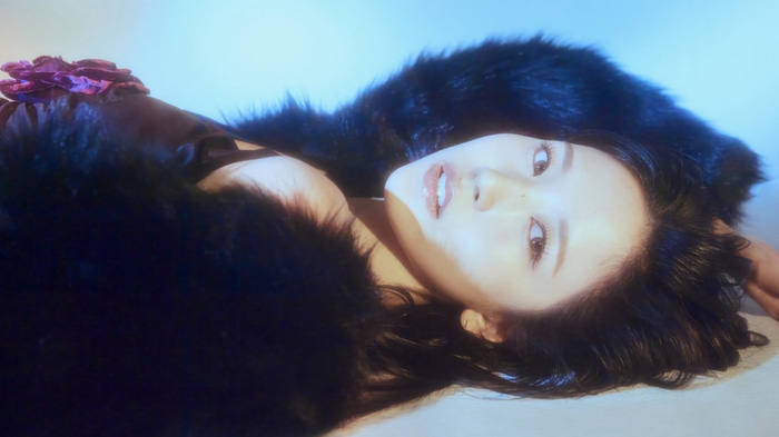 Mina from TWICE in a dark fur coat
