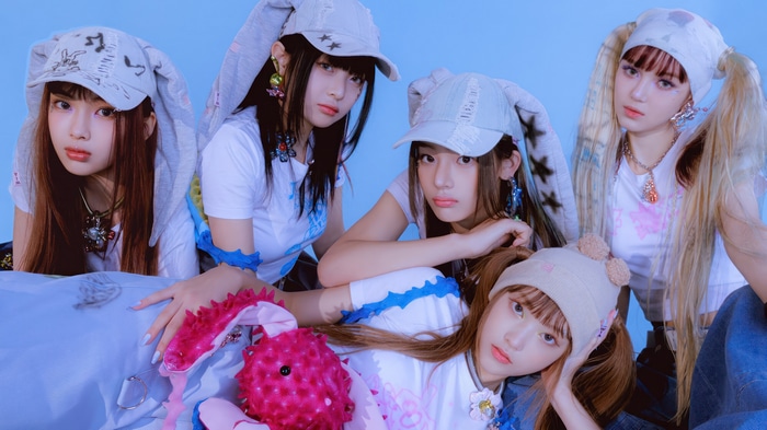 NewJeans members posing in bunny hats
