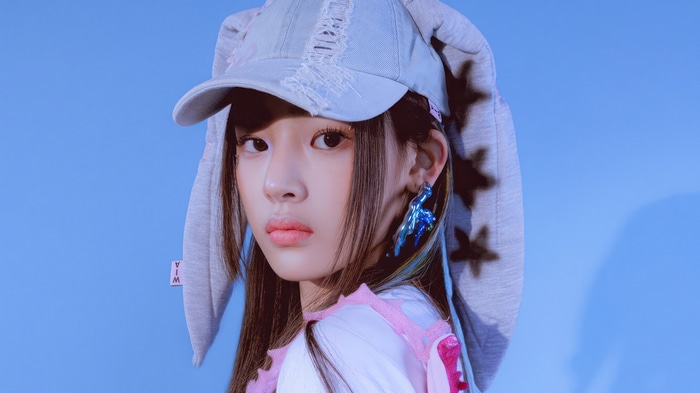 Minji from NewJeans wearing a bunny hat