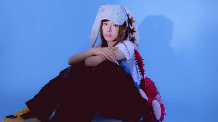 Minji from NewJeans wearing a bunny hat
