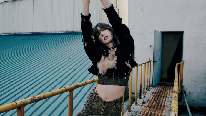 Taeyeon in a black top and studded skirt