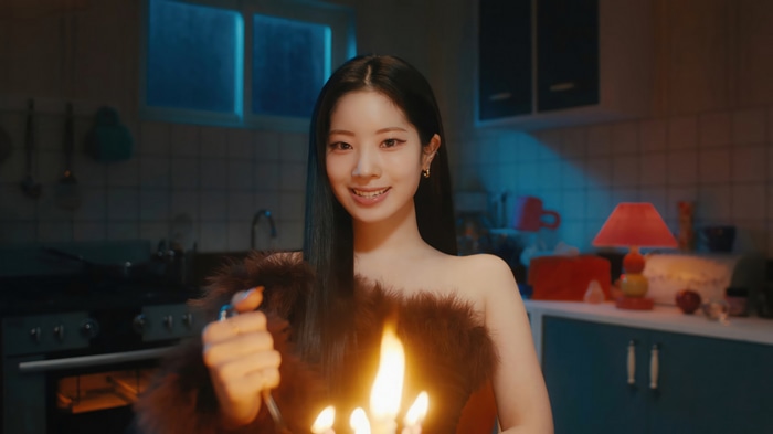 Dahyun of TWICE holding a lit candelabra