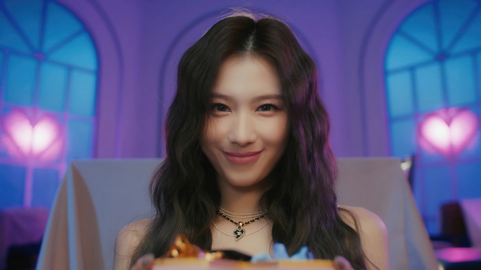 Sana of TWICE holding a gift box