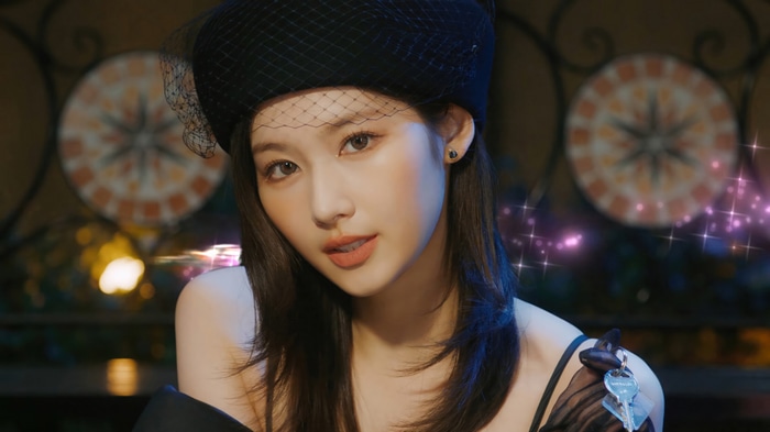 Sana from TWICE wearing a black hat and veil