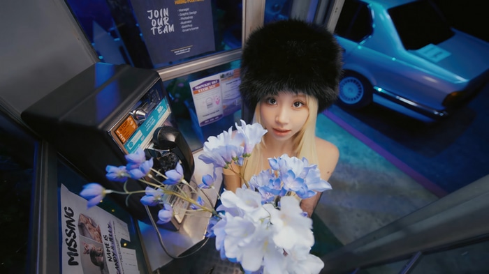 Chaeyoung of TWICE holding flowers in a phone booth