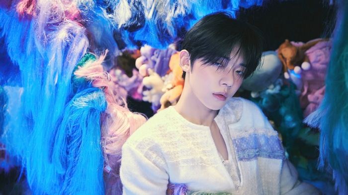 Yeonjun of TXT in colorful, abstract setting
